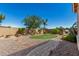 Secluded backyard offers lush landscaping, mature trees, built-in grill, and a cozy firepit at 5235 S Dante --, Mesa, AZ 85212