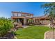 Expansive backyard with an outdoor kitchen, covered patio, and well-manicured artificial grass at 5235 S Dante --, Mesa, AZ 85212