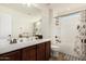 Well-lit bathroom with double sinks and a shower-tub combination, offering convenience and style at 5235 S Dante --, Mesa, AZ 85212