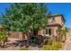 Attractive stucco home with stone accents, a large tree, and manicured landscaping at 5235 S Dante --, Mesa, AZ 85212