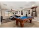 Spacious game room with a pool table and comfortable leather seating, perfect for entertainment at 5235 S Dante --, Mesa, AZ 85212