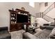 Stunning living room featuring a grand entertainment center and a staircase with iron railings at 5235 S Dante --, Mesa, AZ 85212