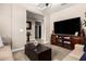 This living room has a flat-screen TV, a coffee table, and a tan sofa at 5235 S Dante --, Mesa, AZ 85212