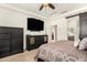 Main bedroom featuring a large bed, storage, and a view of the ensuite bathroom at 5235 S Dante --, Mesa, AZ 85212