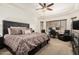 Serene main bedroom with a large bed, ceiling fan, and a dedicated workspace by the window at 5235 S Dante --, Mesa, AZ 85212