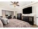 Bright main bedroom with a ceiling fan, a dedicated workspace, and large windows at 5235 S Dante --, Mesa, AZ 85212