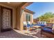 Relaxing covered front porch with wicker furniture and stylish decor at 5235 S Dante --, Mesa, AZ 85212