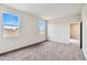 Bright, carpeted bedroom with two large windows providing natural light and a view of the sky at 641 W Freedom St, Florence, AZ 85132