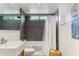 Modern bathroom featuring dark tiled shower with rainfall showerhead and a floating sink with a large mirror at 7030 E Orange Blossom Ln, Paradise Valley, AZ 85253