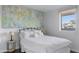 Comfortable bedroom featuring a queen bed with white linens and a large modern art piece above the headboard at 7030 E Orange Blossom Ln, Paradise Valley, AZ 85253