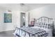 Bright bedroom featuring a black metal bed frame, dark wood floors, and an ensuite bathroom visible through the open door at 7030 E Orange Blossom Ln, Paradise Valley, AZ 85253
