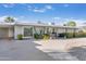 Single-story home with desert landscaping, ample parking and stone features outside the front door at 7030 E Orange Blossom Ln, Paradise Valley, AZ 85253