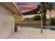 Inviting pool area with covered patio and lush landscaping at sunset at 7030 E Orange Blossom Ln, Paradise Valley, AZ 85253