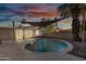 Backyard pool with sail shade and patio furniture for relaxing by the pool during sunset at 7030 E Orange Blossom Ln, Paradise Valley, AZ 85253