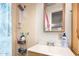 A functional bathroom featuring a shower, a sink, and basic toiletry storage at 705 S Pima --, Mesa, AZ 85210