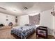 Relaxing bedroom featuring light-colored walls, plush carpet, and a small crib for a baby at 705 S Pima --, Mesa, AZ 85210
