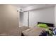 A simply designed bedroom featuring neutral colors, plush carpet, and a white door at 705 S Pima --, Mesa, AZ 85210