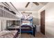 A simple bedroom with bunk beds, natural light from the window, and a ceiling fan at 705 S Pima --, Mesa, AZ 85210