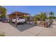 View of the car parked in the carport area, showcasing additional parking and storage space at 705 S Pima --, Mesa, AZ 85210