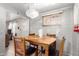 View of the dining room showing brick walls, a wooden table with seating for four, and an elegant chandelier at 705 S Pima --, Mesa, AZ 85210