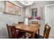 Cozy dining room with a rustic table, wooden chairs, brick walls, and natural light from the window at 705 S Pima --, Mesa, AZ 85210