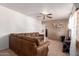 Cozy living room featuring a large sectional sofa, tiled floors, and natural light from the window at 705 S Pima --, Mesa, AZ 85210