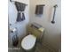 Close up of bathroom featuring a yellow toilet, white walls, gray tile flooring, and towel rack at 7807 E Main St # H-20, Mesa, AZ 85207