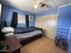 Blue bedroom with ceiling fan, window, air conditioning unit, and a closet at 7807 E Main St # H-20, Mesa, AZ 85207
