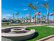 Community space with decorative fire pit, flag poles, and manicured lawn at 7807 E Main St # H-20, Mesa, AZ 85207