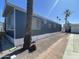 Charming exterior view of the home with palm trees and gravel landscaping at 7807 E Main St # H-20, Mesa, AZ 85207