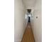 Hallway view with laminate floors and white walls at 7807 E Main St # H-20, Mesa, AZ 85207