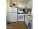 Efficient kitchen area with white appliances, cabinets, and countertops at 7807 E Main St # H-20, Mesa, AZ 85207