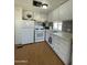 Efficient kitchen area with white appliances, cabinets, and countertops at 7807 E Main St # H-20, Mesa, AZ 85207