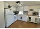 Bright kitchen area with white appliances, cabinets, and countertops with backsplash at 7807 E Main St # H-20, Mesa, AZ 85207