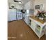 Functional kitchen area with white cabinets, appliances, countertops, and modern lighting at 7807 E Main St # H-20, Mesa, AZ 85207