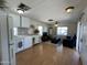 Bright living room and kitchen area with laminate floors, ceiling fan, and comfortable leather seating at 7807 E Main St # H-20, Mesa, AZ 85207