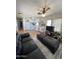 Cozy living room and kitchen area with laminate floors, ceiling fan, and comfortable leather seating at 7807 E Main St # H-20, Mesa, AZ 85207
