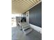 Relaxing covered porch with gray wood steps and outdoor furniture, perfect for enjoying the fresh air at 7807 E Main St # H-20, Mesa, AZ 85207