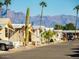 Street view with well-kept mobile homes, landscaping and mountain views at 7807 E Main St # H-20, Mesa, AZ 85207