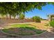 A large backyard with low maintenance landscaping and appealing brick perimeter at 7911 E Posada Ave, Mesa, AZ 85212