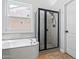 Bathroom showcasing a shower stall with tile and a luxurious soaking tub at 7911 E Posada Ave, Mesa, AZ 85212