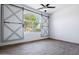 Bedroom featuring sliding barn doors and an arched window at 7911 E Posada Ave, Mesa, AZ 85212