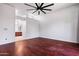 Open primary bedroom with hardwood floors and a view into the primary bathroom at 7911 E Posada Ave, Mesa, AZ 85212