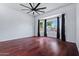 Spacious primary bedroom with a large bay window and dark wood flooring, offering ample natural light at 7911 E Posada Ave, Mesa, AZ 85212