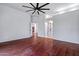 Spacious primary bedroom with dark wood floors and many entries to other rooms at 7911 E Posada Ave, Mesa, AZ 85212