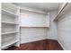 Spacious walk-in closet with custom shelves and hardwood floors at 7911 E Posada Ave, Mesa, AZ 85212