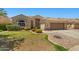 Charming single-story home with well-maintained landscaping and a two-car garage at 7911 E Posada Ave, Mesa, AZ 85212
