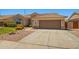 Attractive single-story home featuring a large two-car garage and desert landscaping at 7911 E Posada Ave, Mesa, AZ 85212