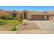 Inviting single-story home with a well-manicured lawn and an attached two-car garage at 7911 E Posada Ave, Mesa, AZ 85212