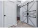 Hallway with decorative sliding doors and a separate white door at 7911 E Posada Ave, Mesa, AZ 85212